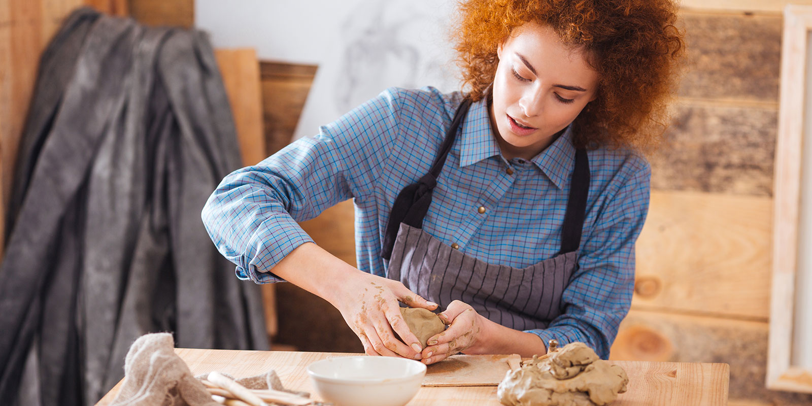 Adult female working with clay making art. 