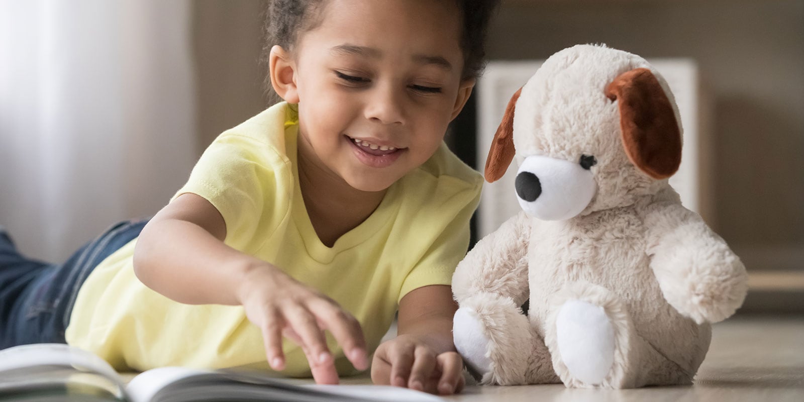 Young toddler playing with a stuffed animal.