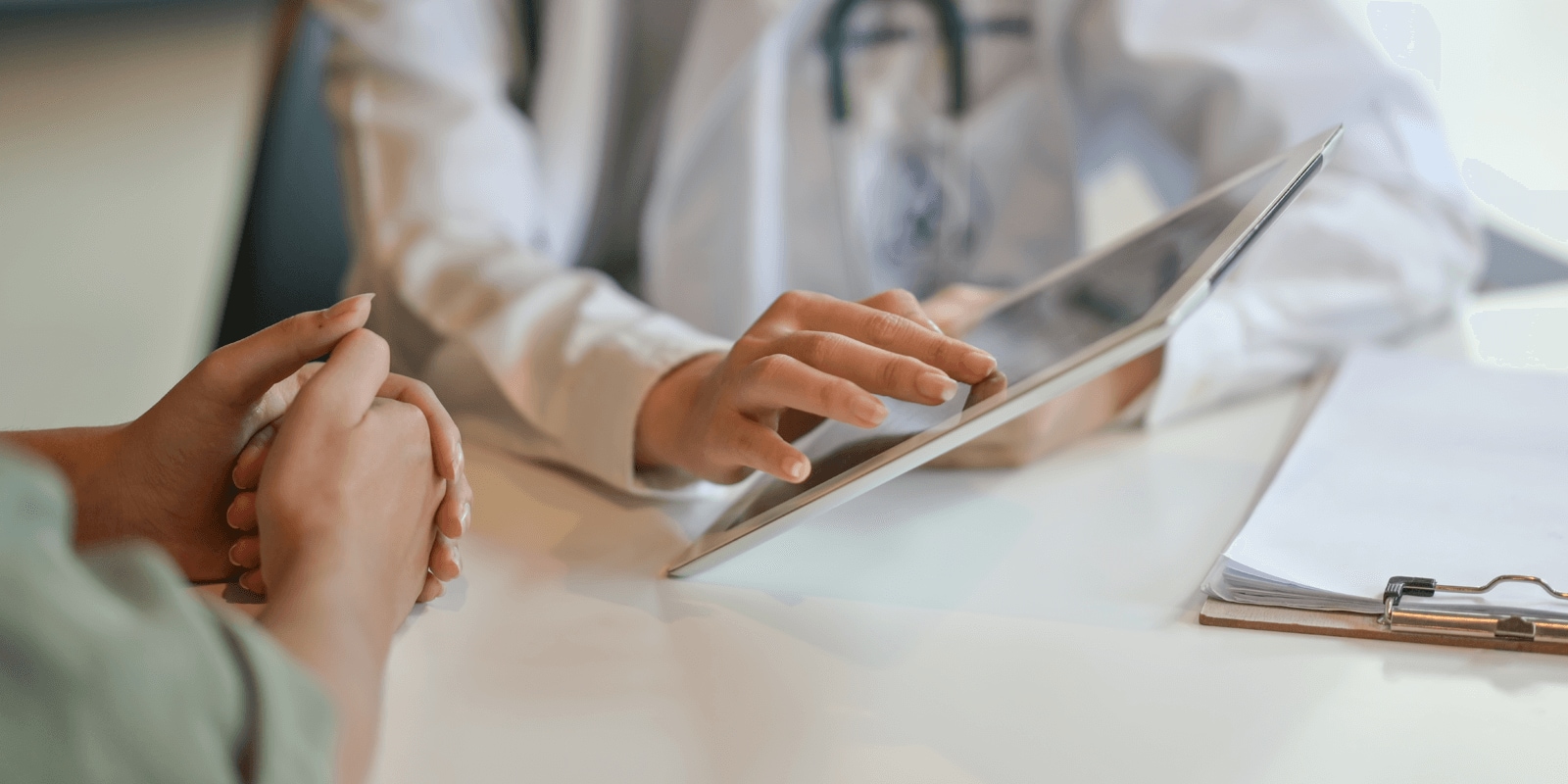 Patient with a clinician using a tablet device.